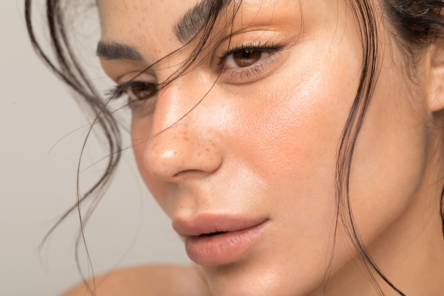 Woman in soft sweater with natural light background.