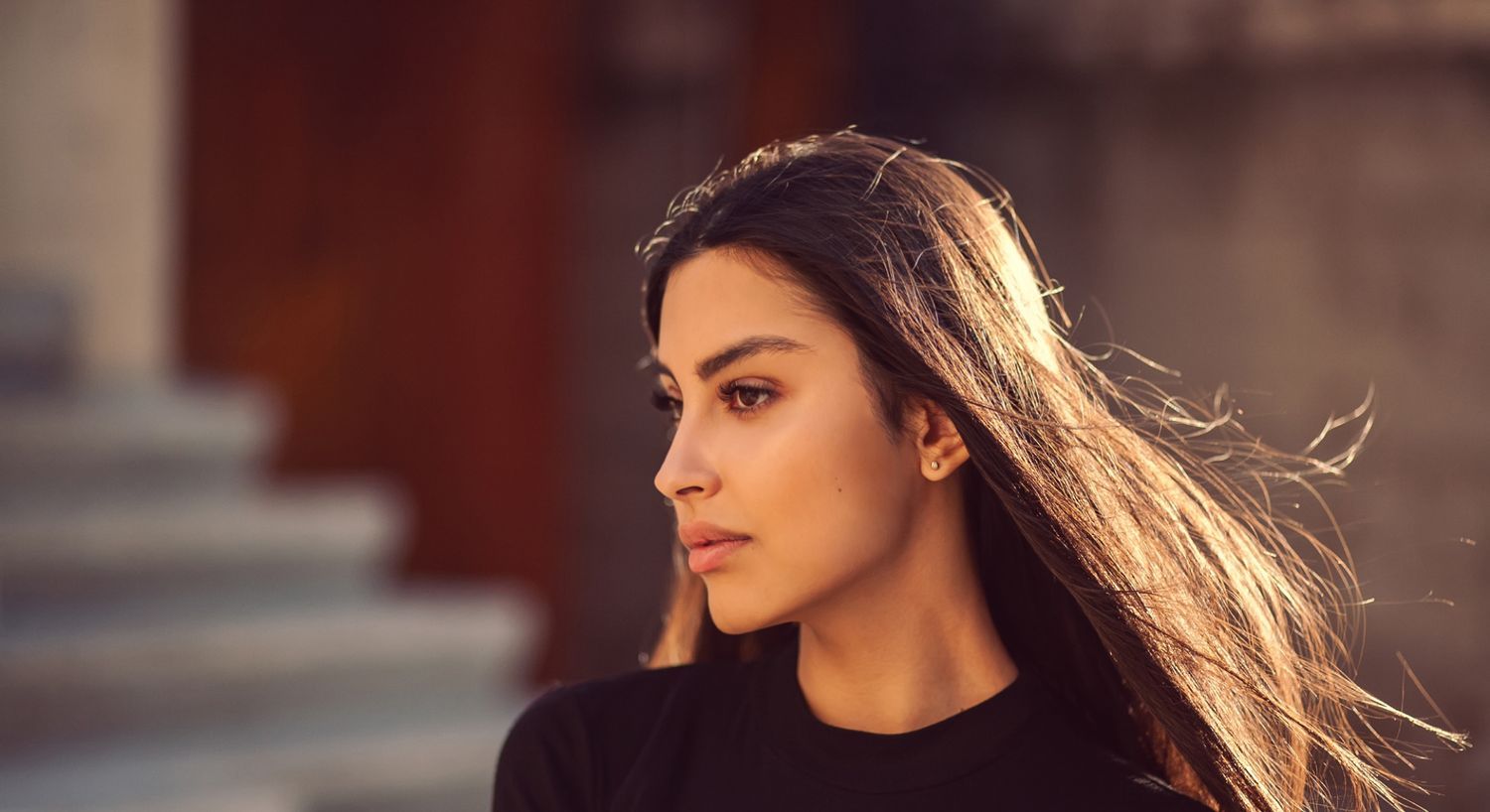 Woman with long hair in soft sunlight.