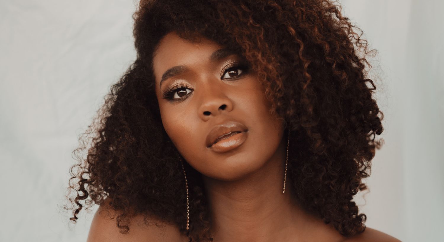 Portrait of a woman with curly hair.